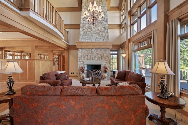 living room featuring a high ceiling, a fireplace, a notable chandelier, and beamed ceiling