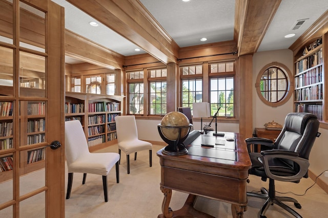 office space featuring a textured ceiling, beamed ceiling, ornamental molding, and light colored carpet