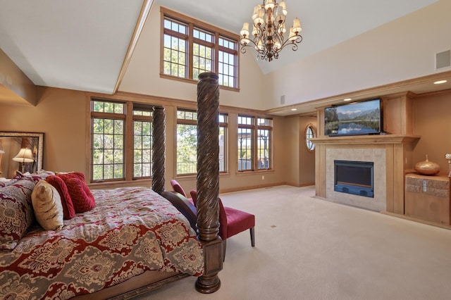 bedroom featuring a notable chandelier, a fireplace, a high ceiling, and light colored carpet