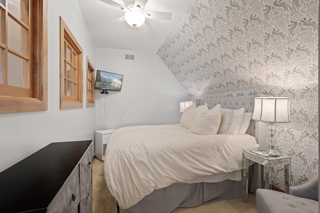 carpeted bedroom with lofted ceiling and ceiling fan