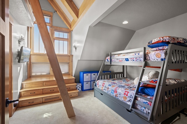 bedroom featuring a textured ceiling, vaulted ceiling, and light colored carpet