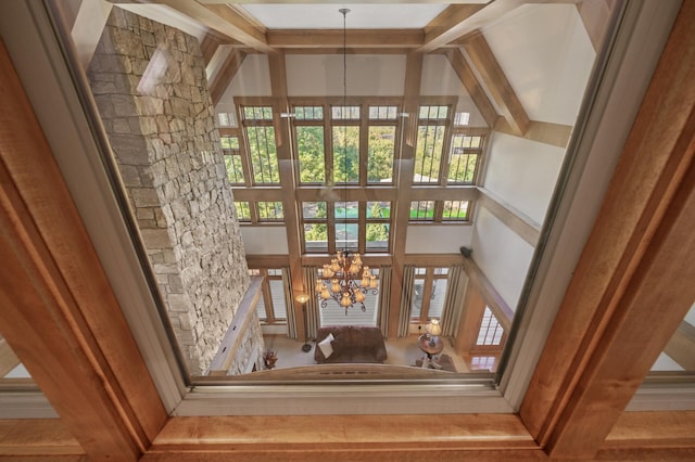 interior space featuring a notable chandelier and beamed ceiling