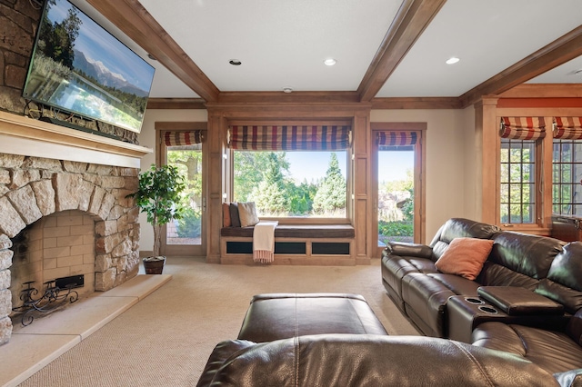 carpeted living room featuring crown molding, beam ceiling, and a stone fireplace