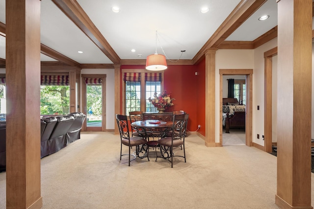 dining room featuring crown molding and light colored carpet