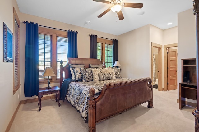 carpeted bedroom with multiple windows and ceiling fan