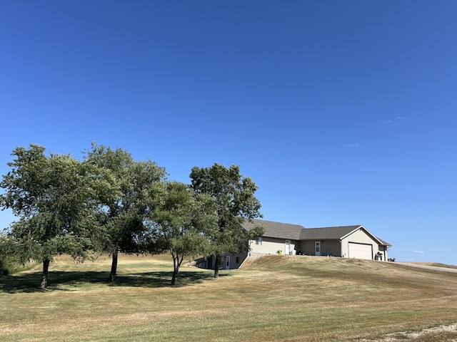 view of front of house featuring a garage and a front lawn