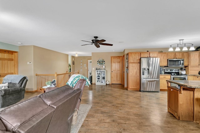 living room with light wood-type flooring and ceiling fan