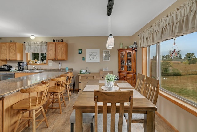 dining area featuring light hardwood / wood-style flooring and sink