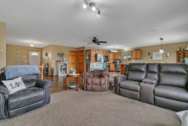 living room featuring ceiling fan and hardwood / wood-style flooring