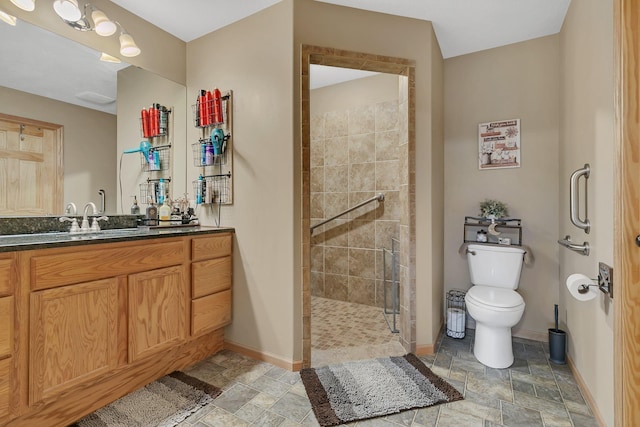 bathroom with vanity, a shower with shower door, and toilet