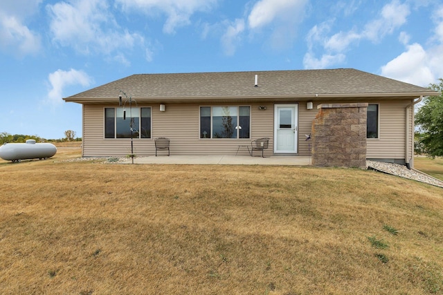 back of property featuring a lawn and a patio area