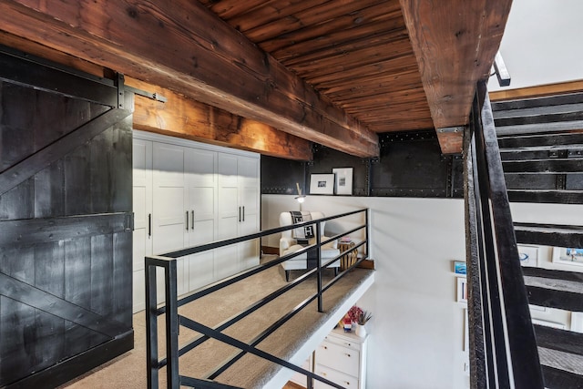 interior space with a barn door and wooden ceiling