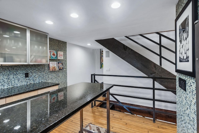 interior space featuring decorative backsplash and light wood-type flooring