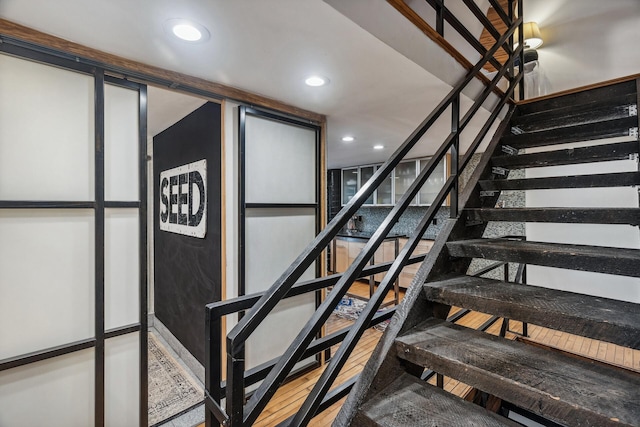 stairway featuring wood-type flooring