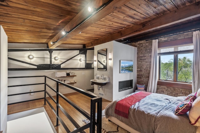 bedroom with beamed ceiling, wooden ceiling, brick wall, and wood-type flooring