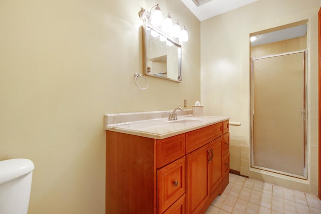 bathroom with vanity, toilet, and an enclosed shower