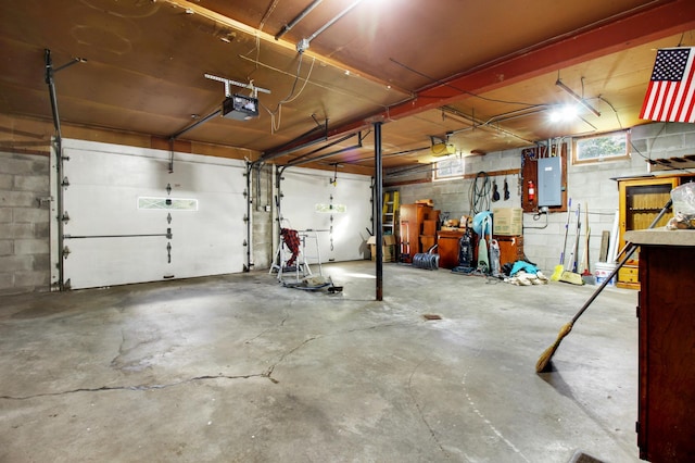 garage with electric panel and a garage door opener