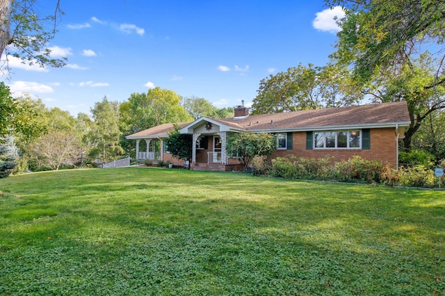 single story home with a front lawn and covered porch