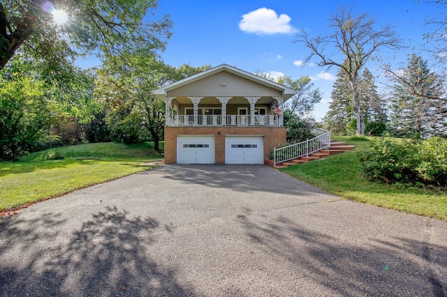 view of front of home with a front yard and a garage