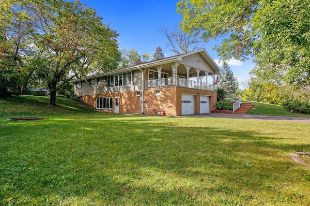 view of front of home featuring a balcony, a front lawn, and a garage