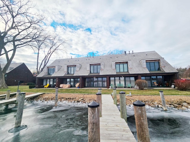 back of house with a lawn