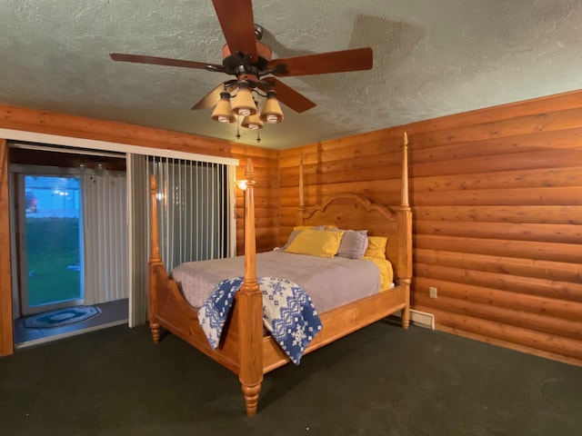 unfurnished bedroom featuring ceiling fan, carpet floors, a textured ceiling, and log walls