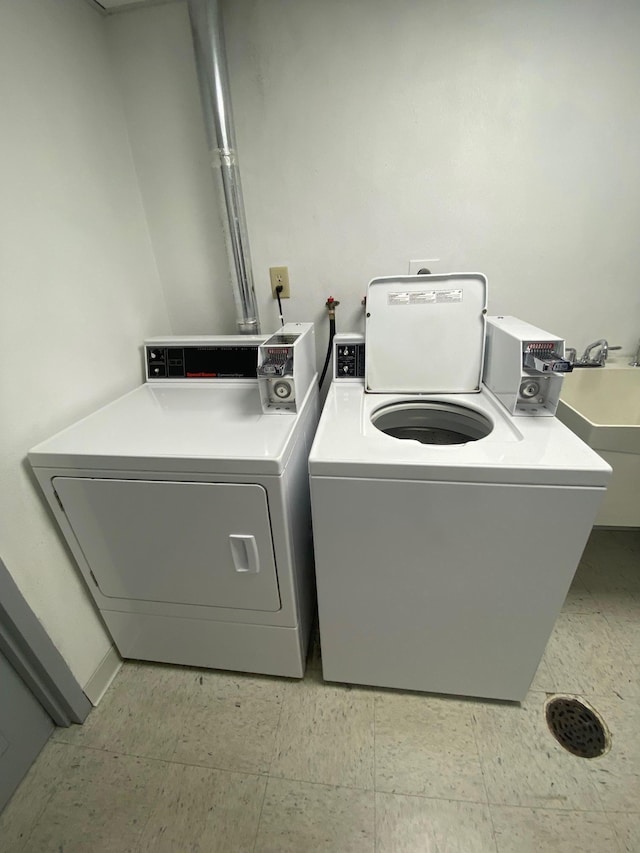 washroom featuring washer and dryer and sink