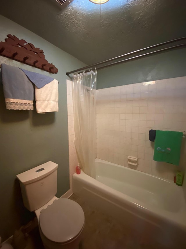 bathroom with shower / bathtub combination with curtain, a textured ceiling, and toilet