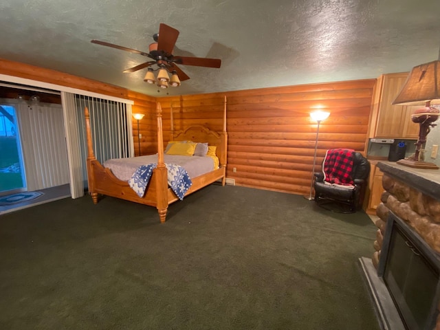 unfurnished bedroom with rustic walls, ceiling fan, dark carpet, and a textured ceiling