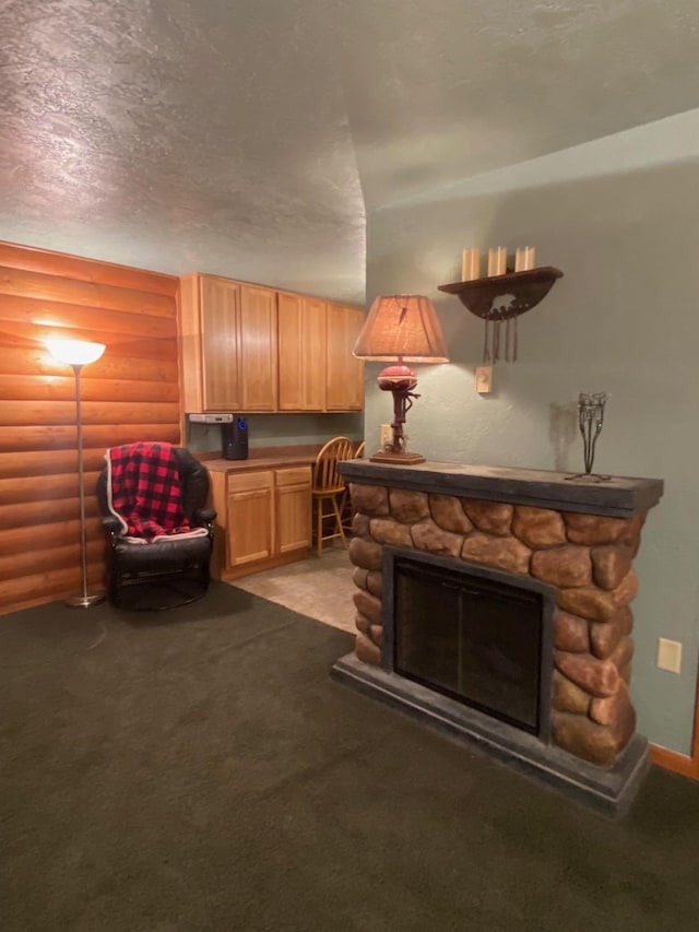 carpeted living room with log walls, a textured ceiling, and a fireplace