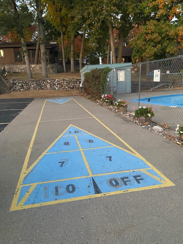 uncovered parking lot featuring fence