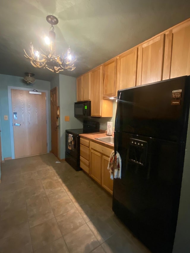 kitchen with black appliances, a chandelier, light brown cabinets, light tile patterned floors, and a sink