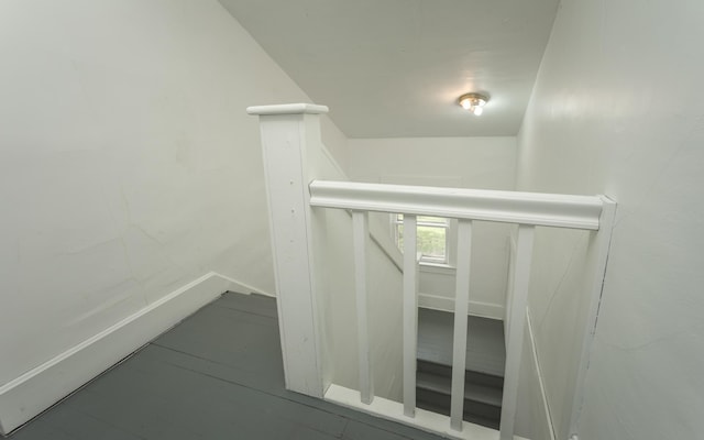 stairway featuring lofted ceiling