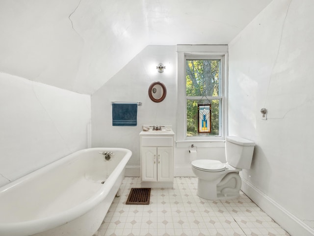 bathroom with toilet, vanity, a tub, and lofted ceiling