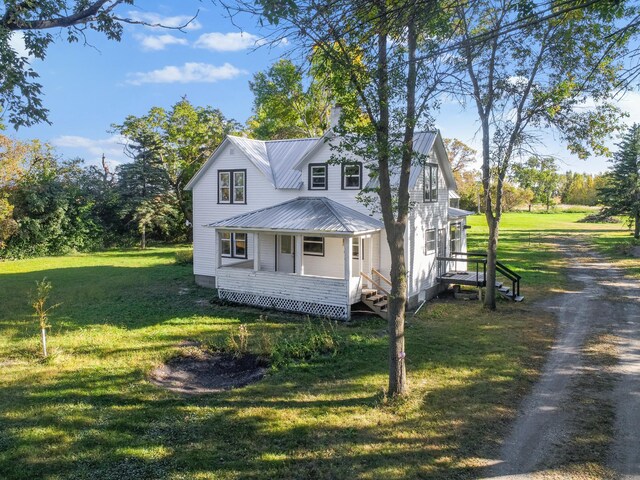 29693 120th St, Herman, MN 56248 - view of front of house featuring a chimney, a porch, metal roof, and a front yard