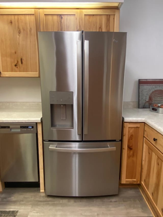 kitchen featuring light countertops, appliances with stainless steel finishes, and light wood-style flooring