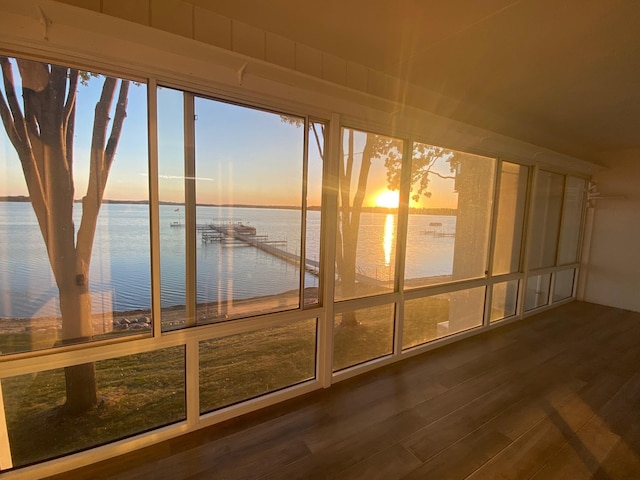 unfurnished sunroom with a water view