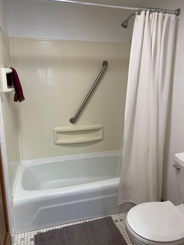 bathroom with tile patterned flooring, shower / bath combo with shower curtain, and toilet