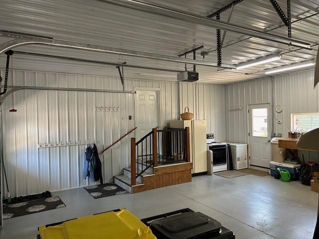 garage with a garage door opener and white refrigerator