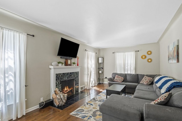 living room featuring dark hardwood / wood-style floors and a fireplace