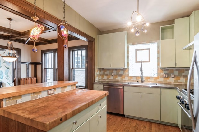 kitchen featuring backsplash, stainless steel appliances, decorative light fixtures, and wood counters