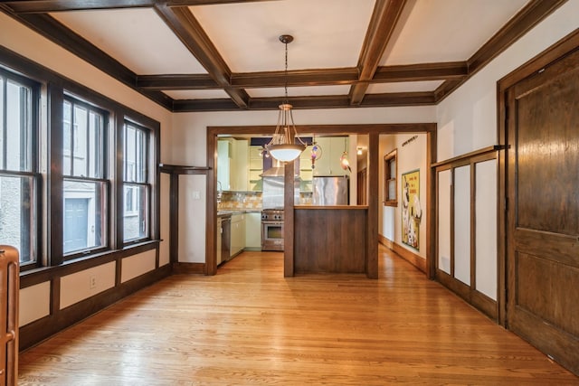 unfurnished dining area featuring beam ceiling, light hardwood / wood-style flooring, and coffered ceiling