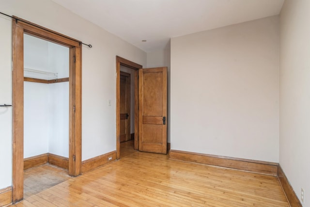 unfurnished bedroom with light hardwood / wood-style floors and a closet