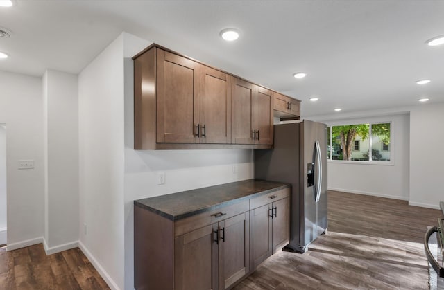 kitchen featuring dark hardwood / wood-style flooring and stainless steel fridge