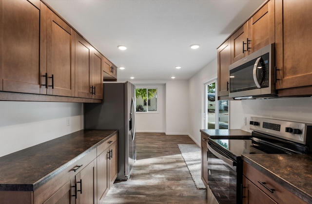 kitchen featuring stainless steel appliances and dark hardwood / wood-style floors