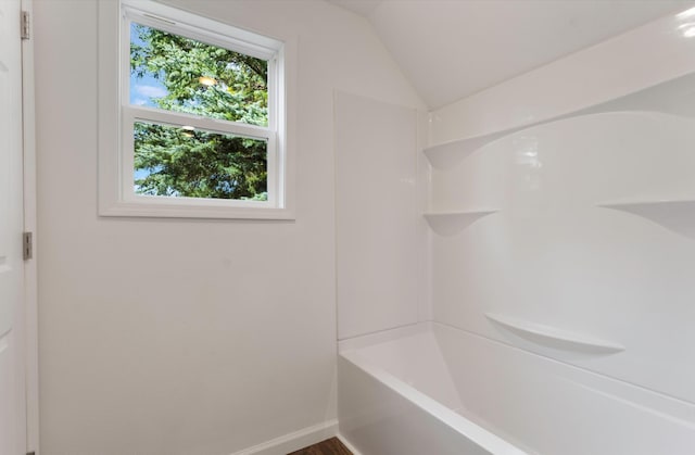 bathroom featuring vaulted ceiling