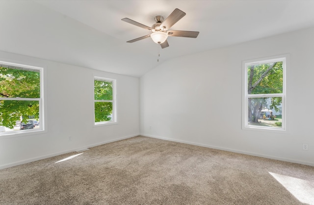 unfurnished room with ceiling fan, vaulted ceiling, carpet, and a healthy amount of sunlight