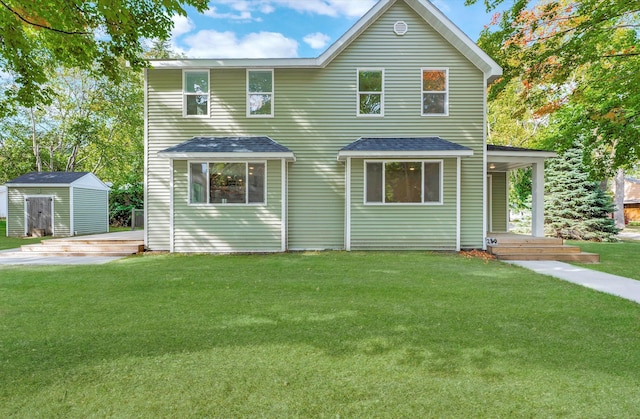 view of front of house featuring a front lawn and a storage shed