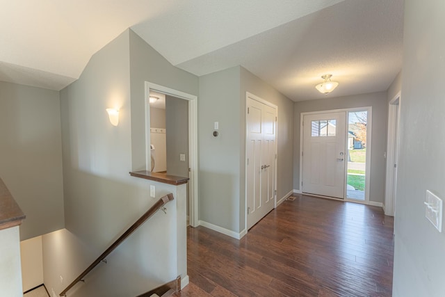 entrance foyer with dark wood-type flooring and a textured ceiling