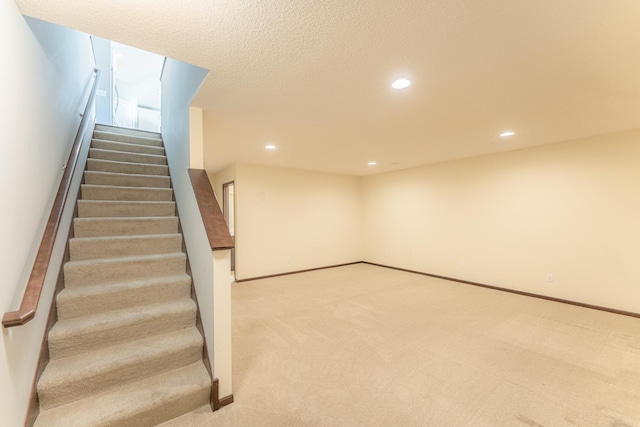 stairway featuring carpet flooring